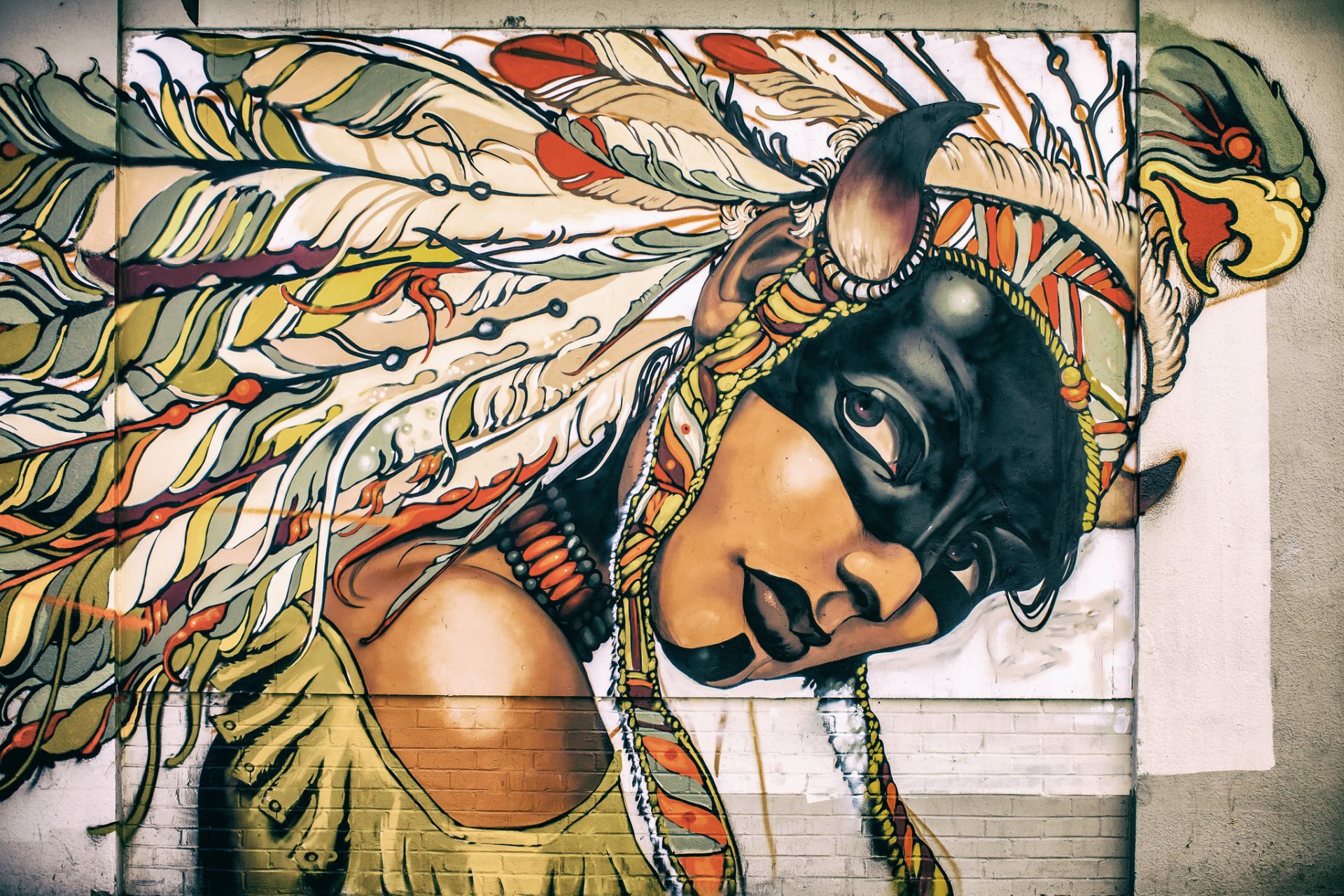 girl face coloring headdress feathers graffiti wall paint