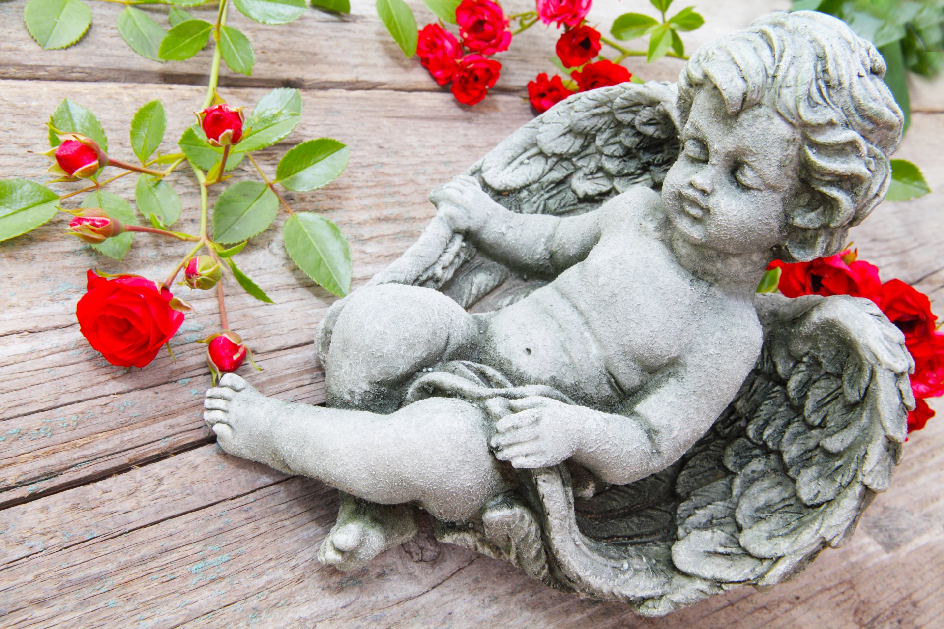 angel cupid figurine roses branches table