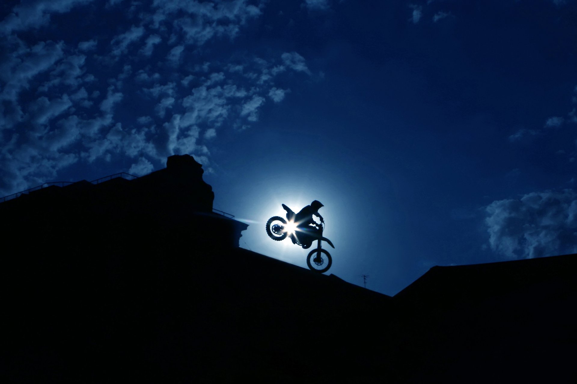 ilhouette man racer moto extreme bike biker spectacular skillful maneuver stunt night city sky clouds beautiful background wallpaper