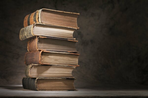 A stack of old books on a gray background