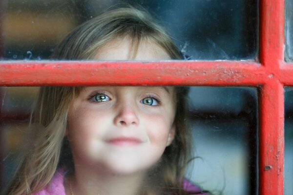 The girl outside the window with a red grille