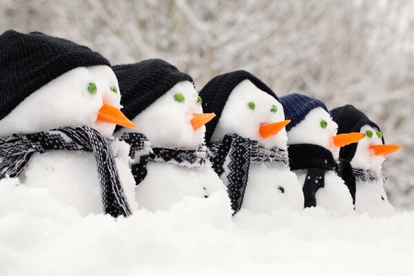 5 snowmen in black knitted hats and scarves