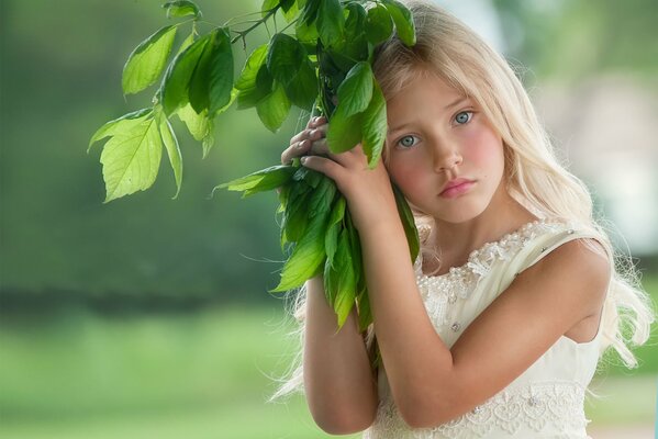 Beautiful girl with a green twig