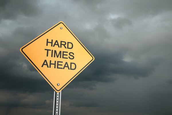 The inscription ahead of hard times against the background of clouds