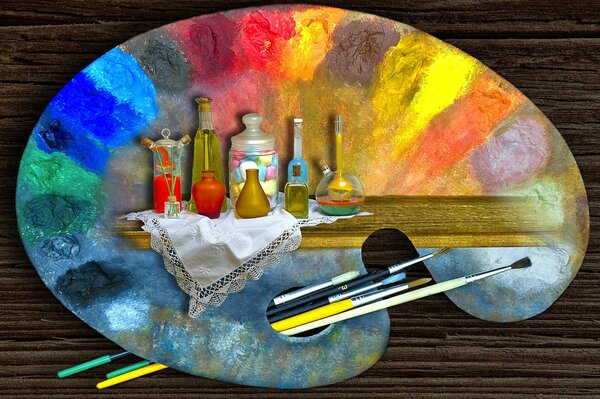 Pittura su una tavolozza con vernici e pennelli