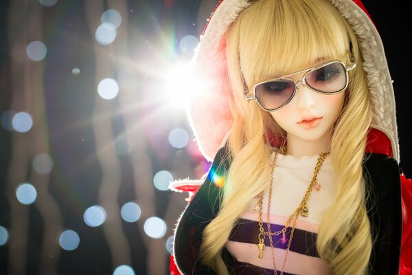 Toy doll with hood and glasses
