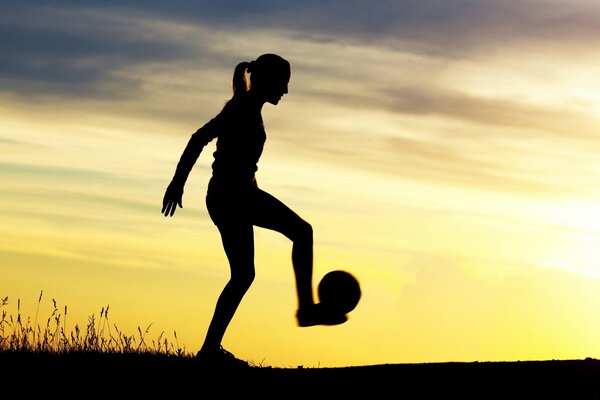 Beautiful background. a girl with a ball on the background of dawn