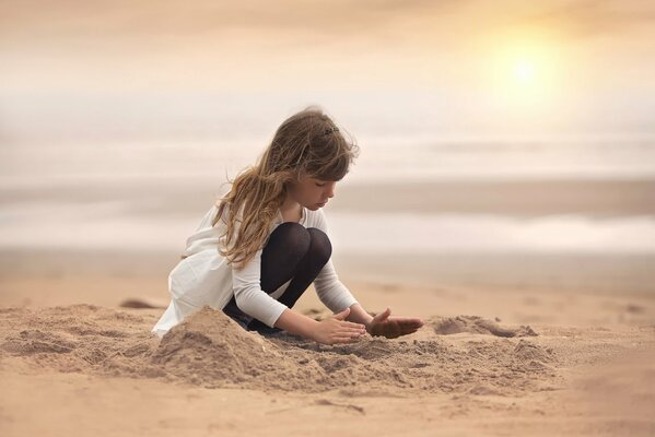 A girl doing creative work on the beach