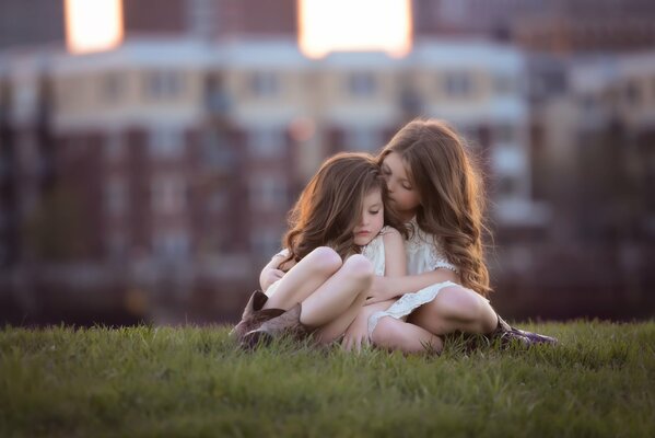 Girls on the grass in the park in the city