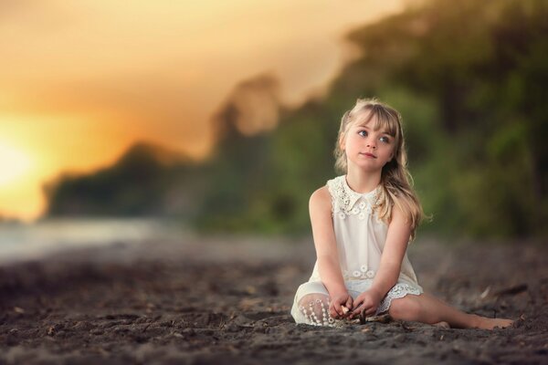 A little dreamer on a stone beach