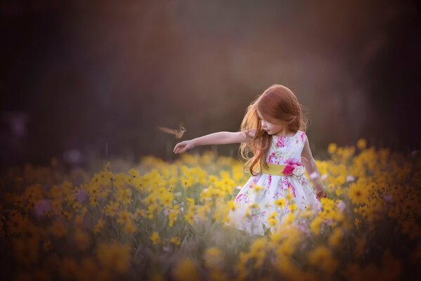 A girl in a blooming summer field