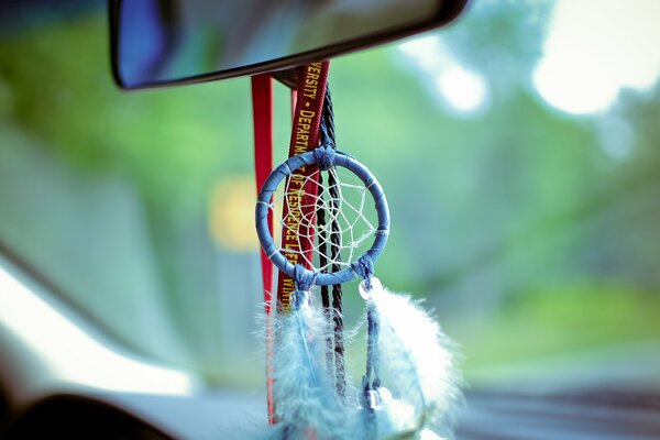 Dream catcher on the windshield in the car