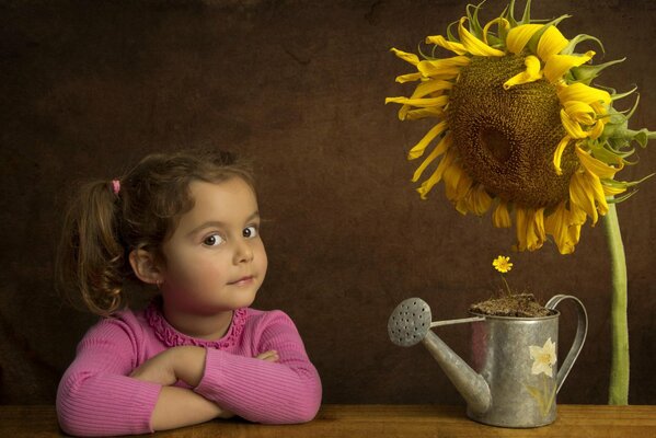 A girl with a sunflower at the table