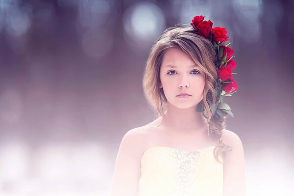 A girl with a wreath of red flowers