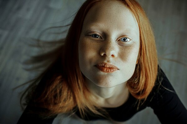 Red-haired girl Polina with freckles