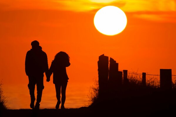 The couple goes into a beautiful sunset