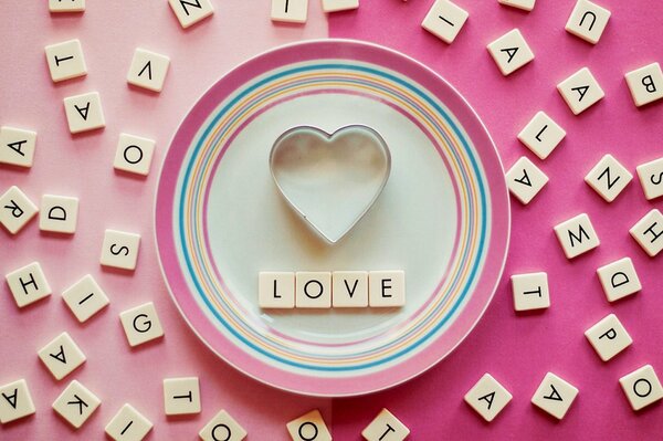 Heart in a saucer on a pink background, love