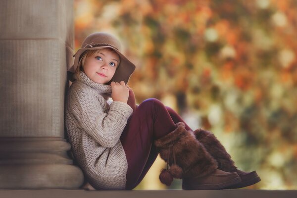 Portrait of a girl in a hat and boots