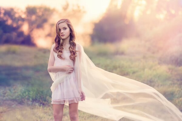 A girl in a white dress with a beautiful hairstyle