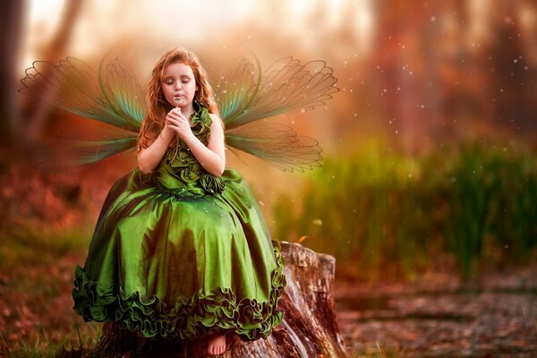 A girl in a green dress with wings