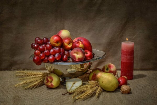 Still life vase with fruit and red candles