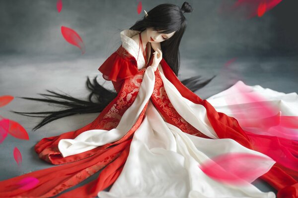 BJD doll of a girl in a kimono in petals