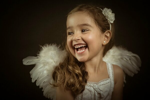 Little angel girl laughs