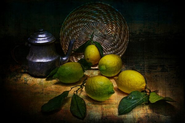 Натюрморт на столе с чайником, плетеной тарелкой и лимонами
