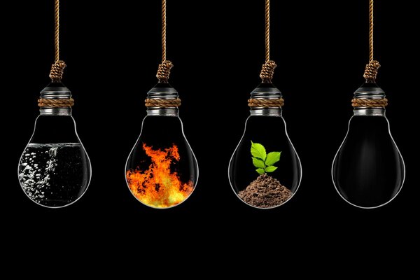 Transparent light bulbs with elements. fire. water. air. land. black background