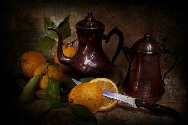 Vintage still life with copper dishes and oranges