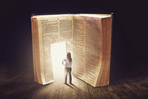 The girl is standing in front of the book, from where a bright light shines