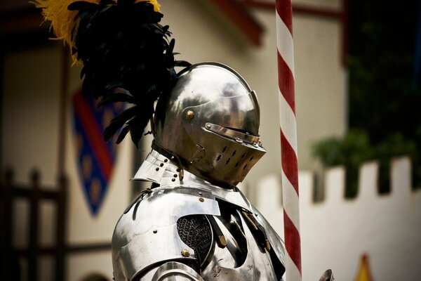 A knight in metal armor with a closed helmet