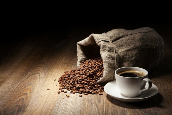 A bag of coffee beans spilled onto the table