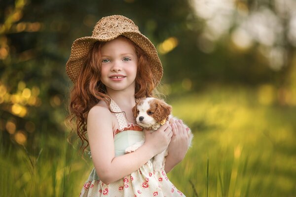 Red-haired girl in a hat with a dog