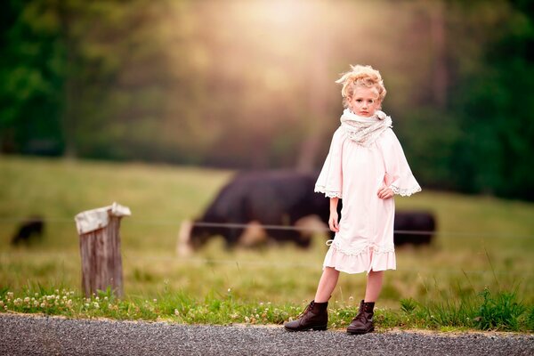 A fashionable girl on the background of a farmer s field