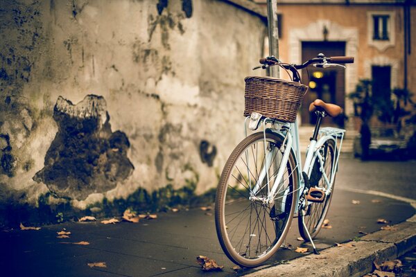 Bicicleta en la calle contra la pared de la casa