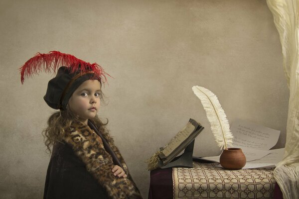 A girl in a hat with a pen and manuscripts