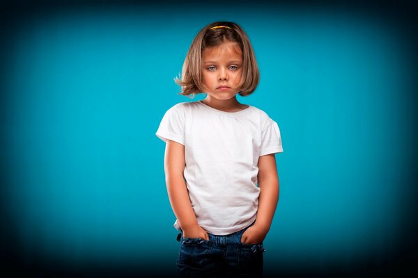 Portrait of a girl looking at a blue background