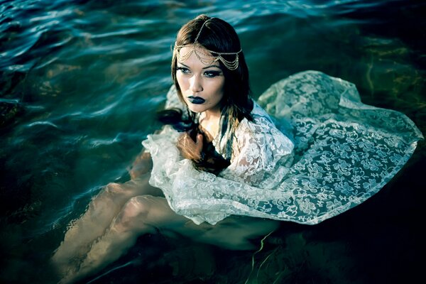 Girl in the water in a white dress