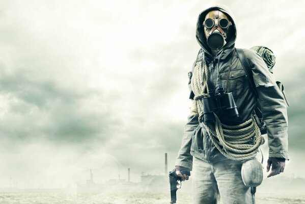 A post-apocalyptic man in a gas mask with a gun