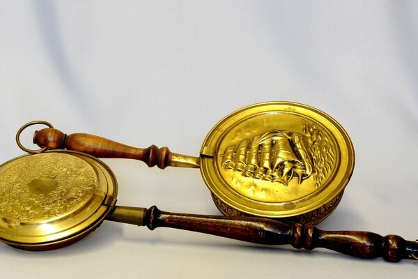 Two antique copper pots with ornaments