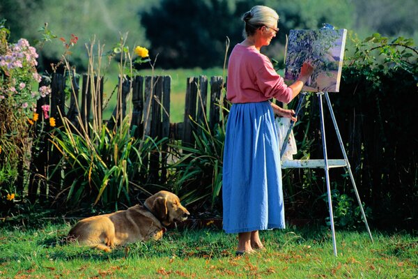 Artista con perro pinta un cuadro