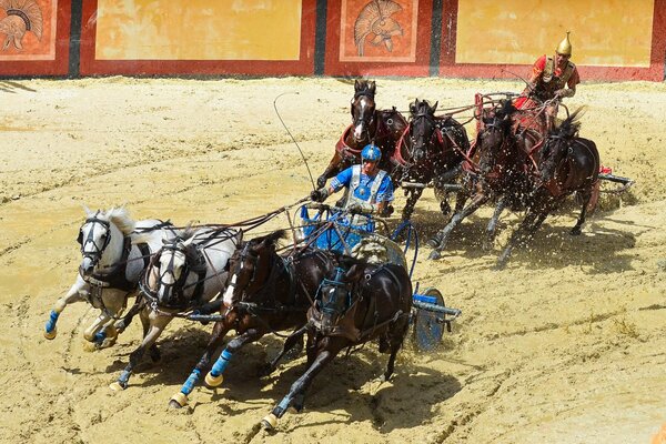 Horse racing on the background of the arena