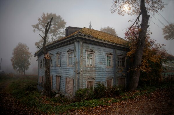 Casa solitaria abandonada en la niebla