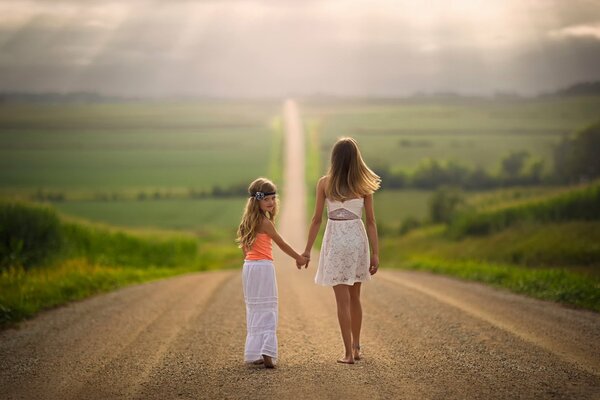 Girls walk along a spacious road