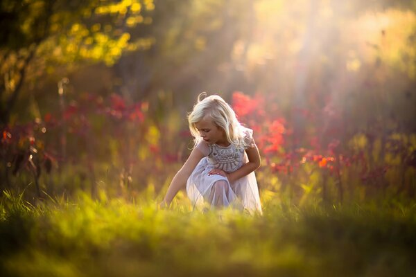 Blonde girl in the autumn forest