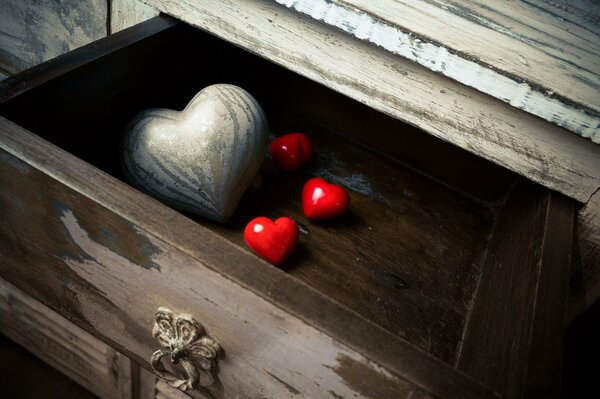 Red hearts in a wooden desk drawer