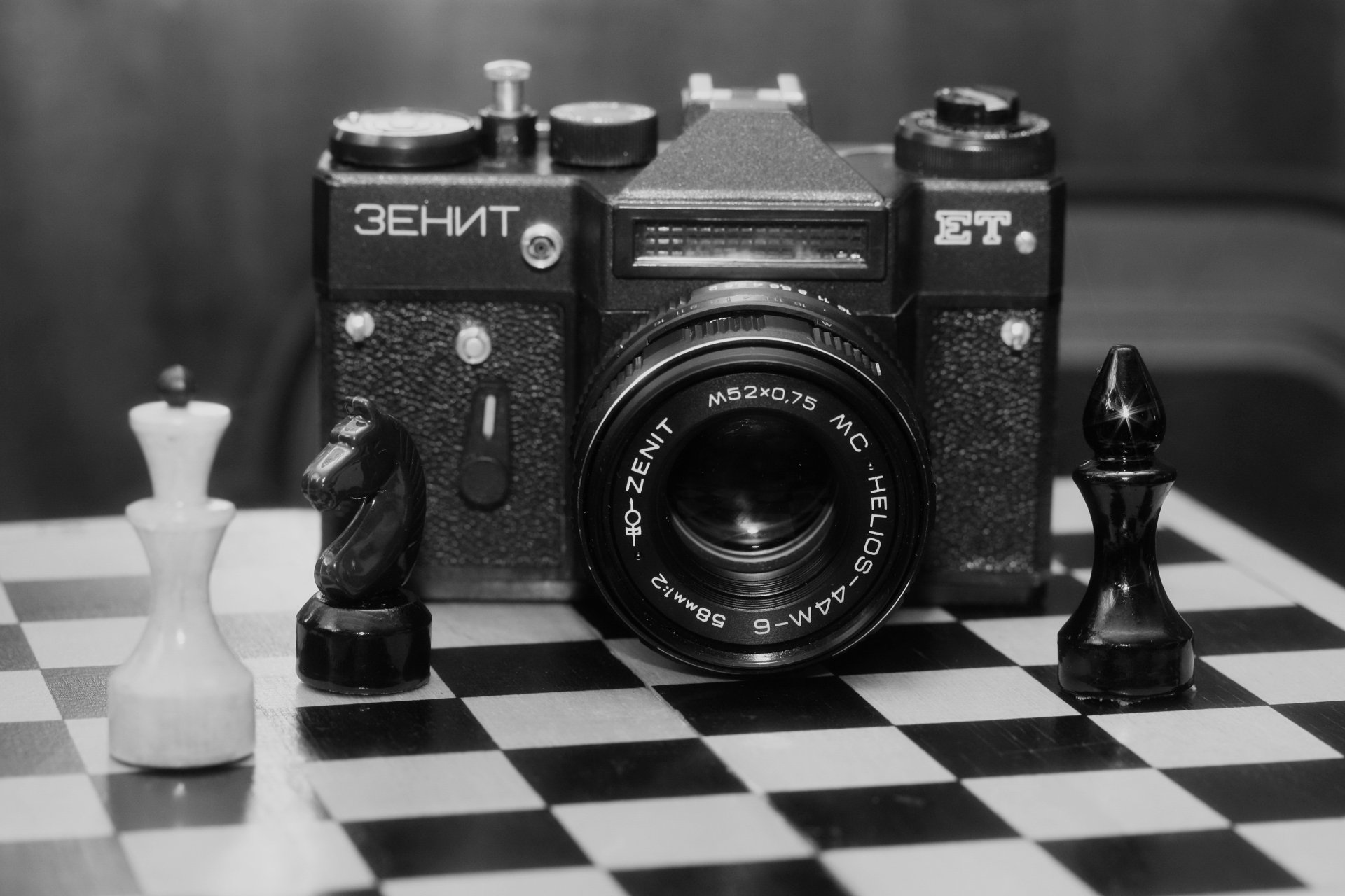 chess board figures zenit-et soviet single-lens mirror a camera blur background