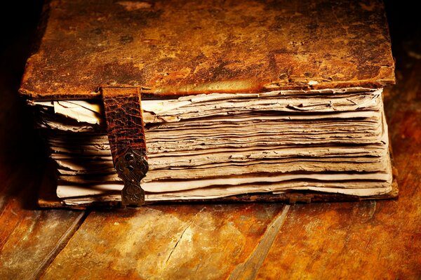 An antique book in leather lies on the table