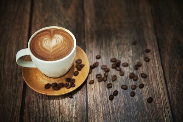 There is a coffee with a heart pattern on the table